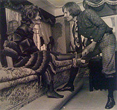 John Fluevog putting shoes on Kecia’s feet in his store.