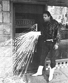John Fluevog blowing a candle on a cake onto the front of the Seattle store.